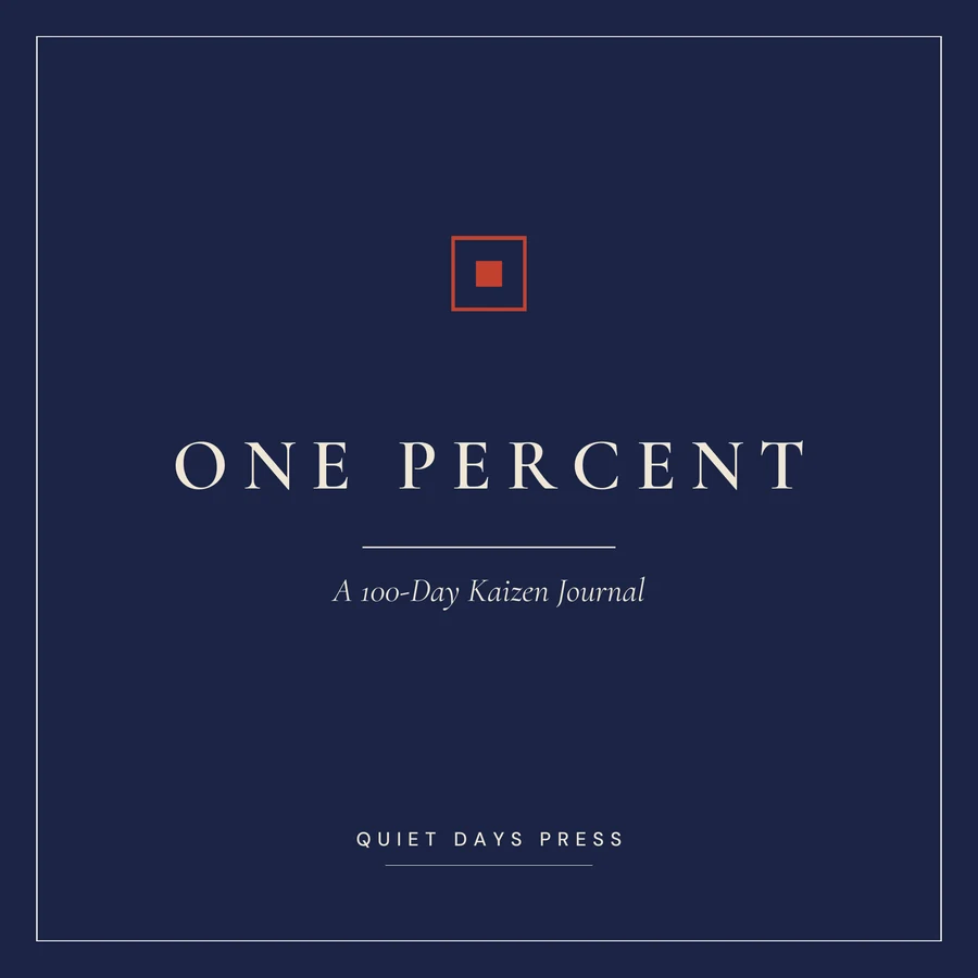 One Percent paperback cover: the words ONE PERCENT in cream letterspaced serif capitals on deep indigo, above the italic subtitle 'A 100-Day Kaizen Journal', with a small red square-in-square seal above.